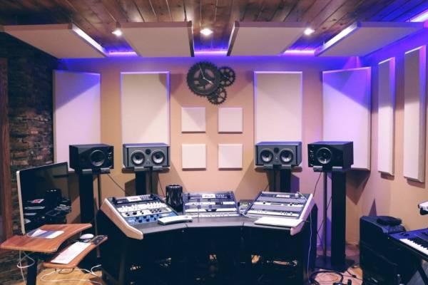 Modern recording studio with high-tech audio equipment and stylish lighting.