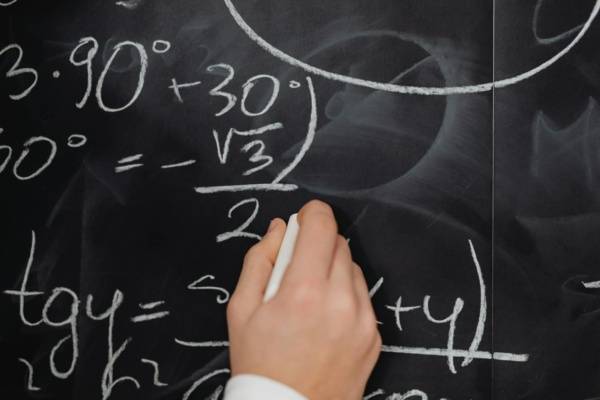 Hand Writing Mathematical Formulas on a Blackboard, SEO Formulas