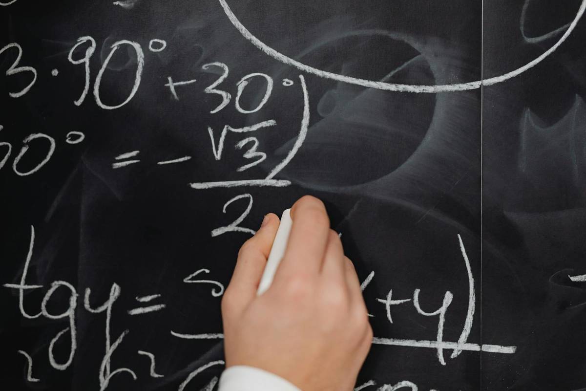 Hand Writing Mathematical Formulas on a Blackboard, SEO Formulas